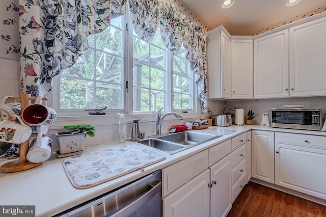 kitchen with white cabinetry, light countertops, appliances with stainless steel finishes, and a sink