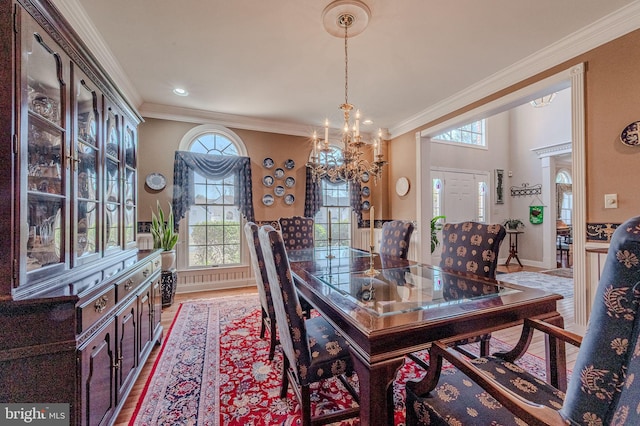 dining room with plenty of natural light, a chandelier, and ornamental molding