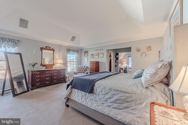 bedroom with a tray ceiling, carpet floors, visible vents, and ornamental molding