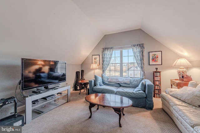 carpeted living area with lofted ceiling