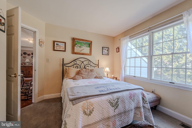 bedroom with visible vents, carpet flooring, and baseboards