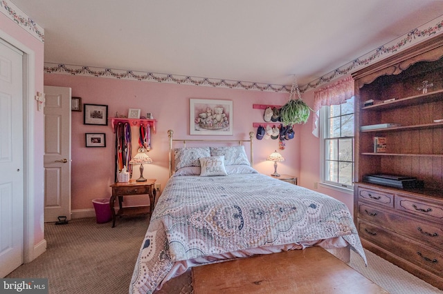 carpeted bedroom featuring baseboards