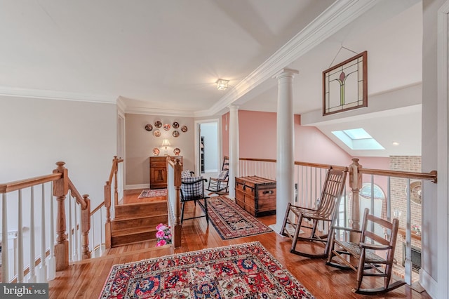 living area featuring crown molding, a skylight, an upstairs landing, and wood-type flooring