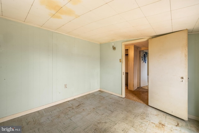 empty room featuring tile patterned floors and baseboards