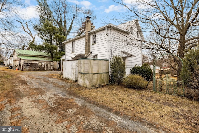 view of side of home with a chimney