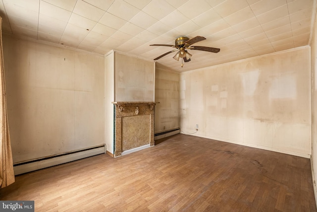 unfurnished room featuring baseboard heating, crown molding, ceiling fan, and wood finished floors