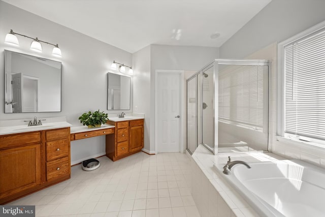 full bath with a garden tub, a sink, double vanity, and a stall shower