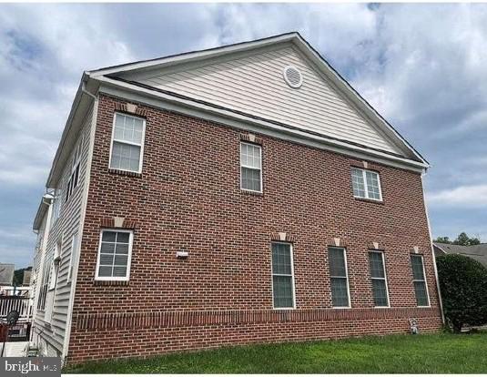 view of side of property featuring brick siding