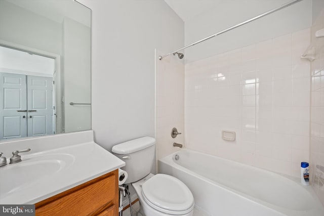 bathroom with washtub / shower combination, vanity, and toilet