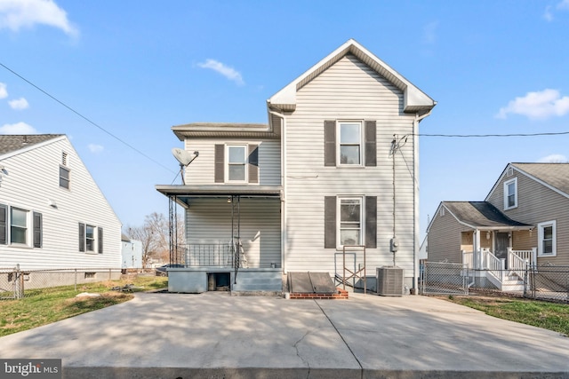 back of property featuring central air condition unit, covered porch, and fence