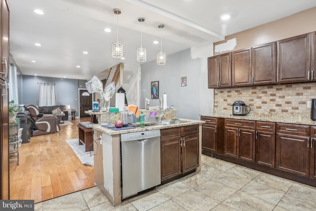 kitchen featuring tasteful backsplash, recessed lighting, dishwasher, and a sink