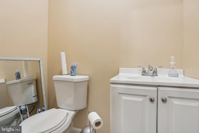 bathroom featuring toilet and vanity