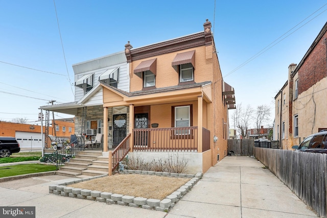 view of property featuring cooling unit, a porch, a chimney, and fence