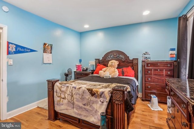 bedroom with light wood finished floors, recessed lighting, and baseboards