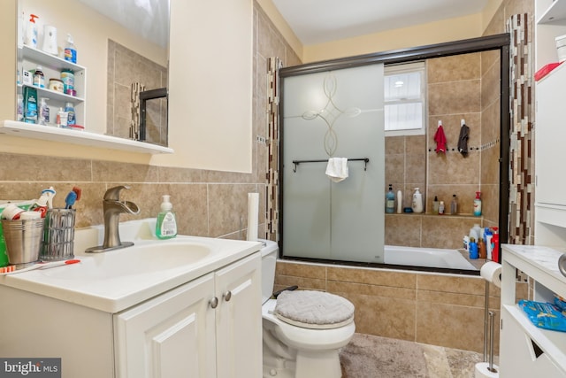 full bathroom featuring toilet, tiled shower / bath combo, tile walls, decorative backsplash, and vanity