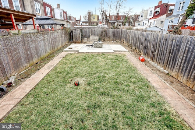 view of yard featuring a patio area, a residential view, and a fenced backyard