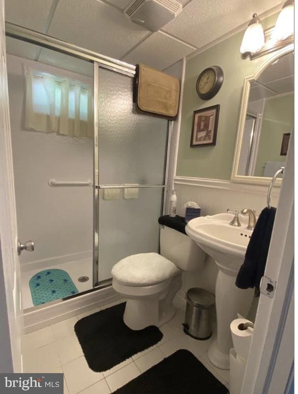 full bathroom with a shower stall, toilet, visible vents, and tile patterned floors