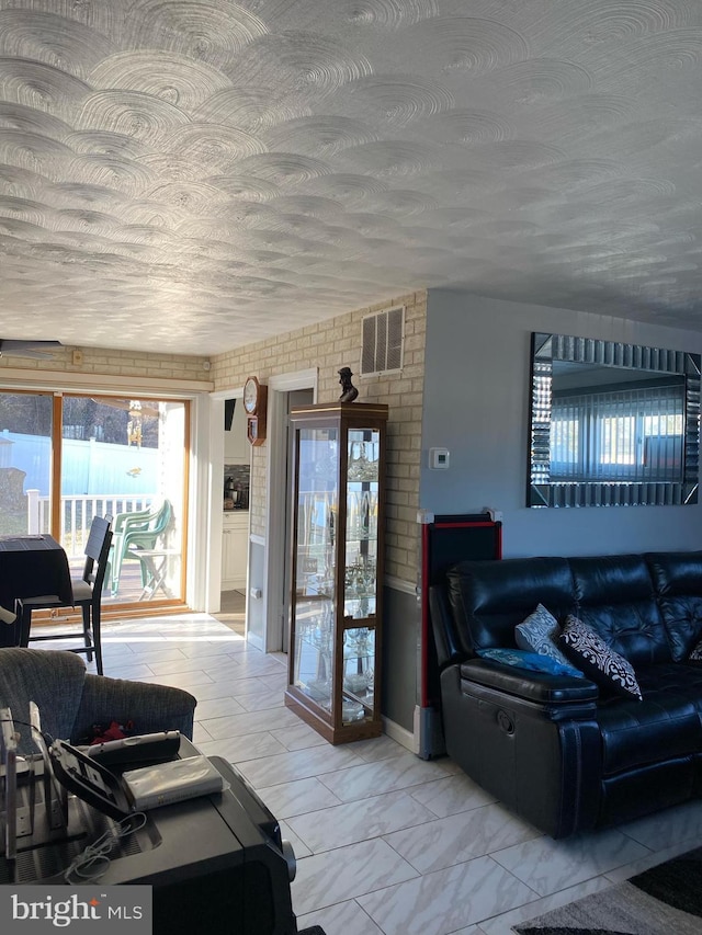 living room featuring visible vents and marble finish floor