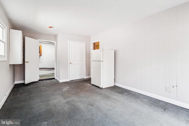 12703 Kembridge Dr, Bowie, MD 20715 - unfurnished bedroom featuring freestanding refrigerator, dark colored carpet, and baseboards