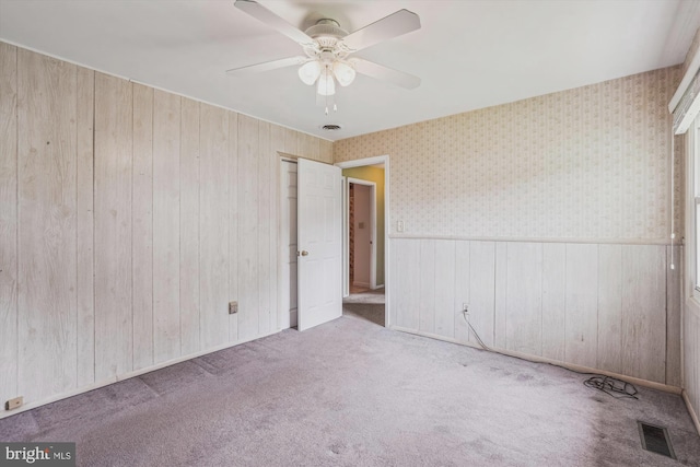 12703 Kembridge Dr, Bowie, MD 20715 - carpeted spare room featuring a ceiling fan, wood walls, wainscoting, and wallpapered walls