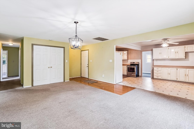 12703 Kembridge Dr, Bowie, MD 20715 - unfurnished living room with light carpet, a ceiling fan, and baseboards