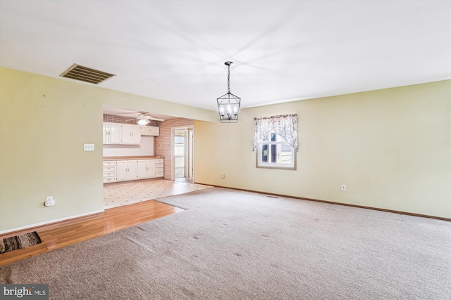12703 Kembridge Dr, Bowie, MD 20715 - unfurnished living room with light carpet, baseboards, a chandelier, and ceiling fan