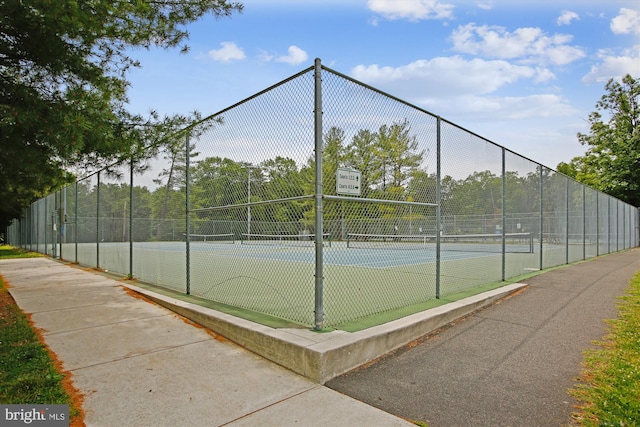 view of tennis court with fence