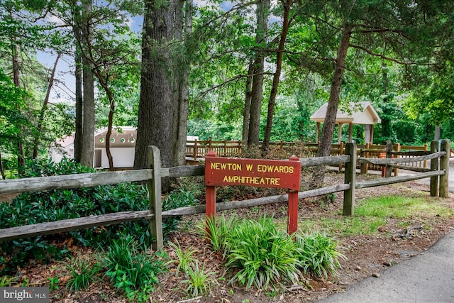 community sign featuring fence