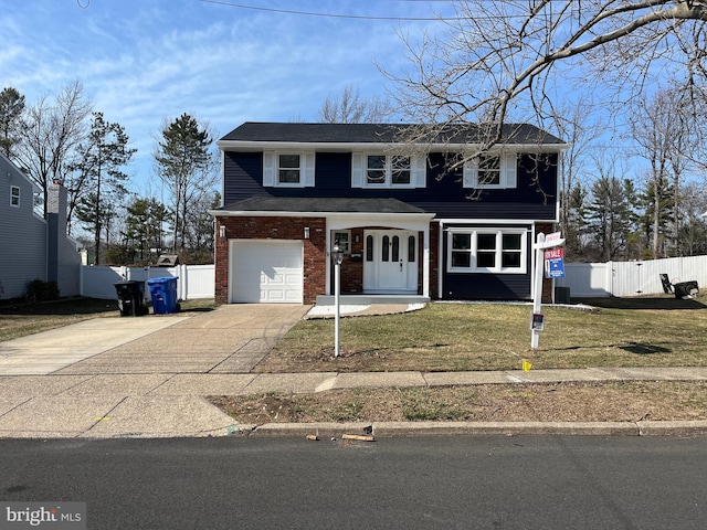 traditional-style house featuring a front lawn, fence, concrete driveway, an attached garage, and brick siding