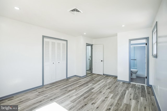 unfurnished bedroom with visible vents, recessed lighting, a closet, light wood-style floors, and baseboards