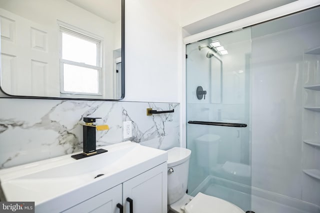 full bathroom featuring vanity, toilet, and a stall shower