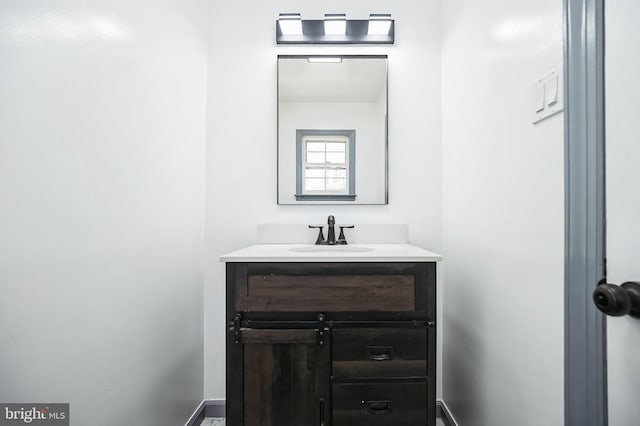 bathroom with vanity and baseboards