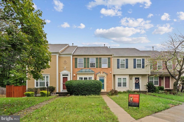view of property with a front lawn and fence