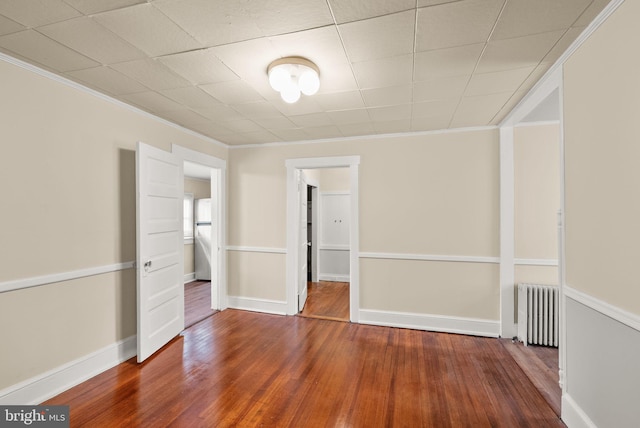 2621 2nd Rd N, Arlington, VA 22201 - unfurnished bedroom with wood finished floors, crown molding, and radiator
