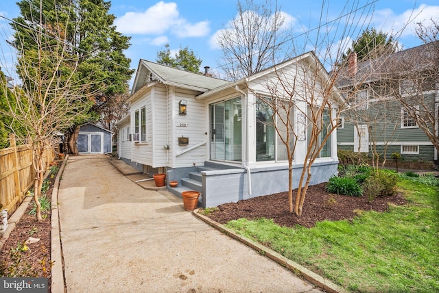 2621 2nd Rd N, Arlington, VA 22201 - view of front facade featuring driveway, an outbuilding, fence, and a storage unit