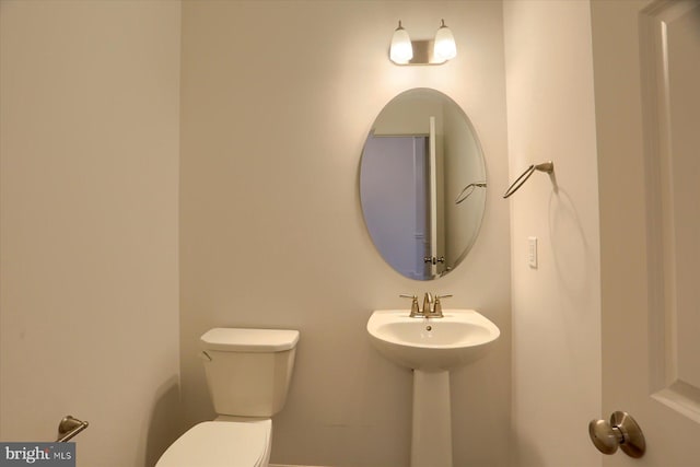 bathroom featuring toilet and a sink