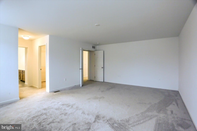 carpeted spare room with visible vents