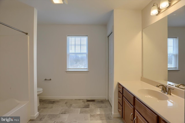 full bath with baseboards, toilet, walk in shower, and vanity