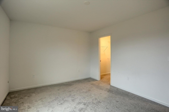 empty room with carpet flooring and baseboards