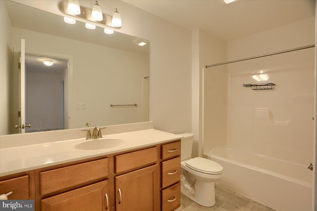 bathroom featuring toilet, vanity, and bathtub / shower combination