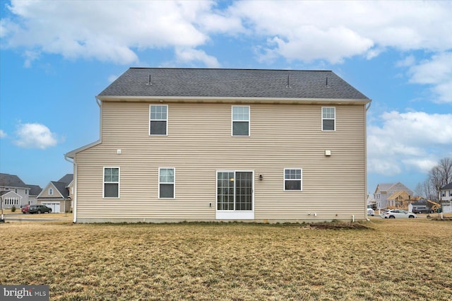 rear view of property with a yard