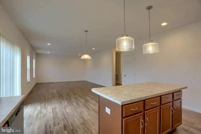 kitchen featuring brown cabinetry, recessed lighting, dishwasher, decorative light fixtures, and light wood-type flooring