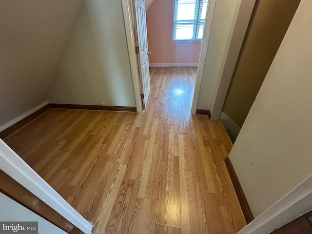 bonus room with light wood finished floors and baseboards