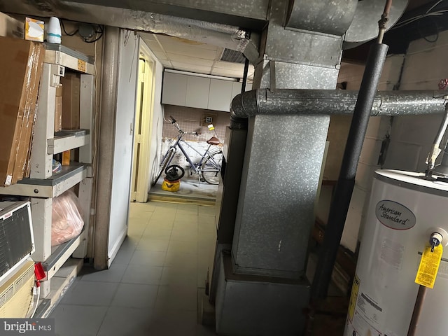 utility room with gas water heater and visible vents