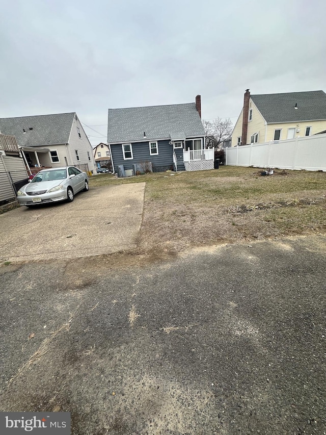 exterior space with driveway and fence