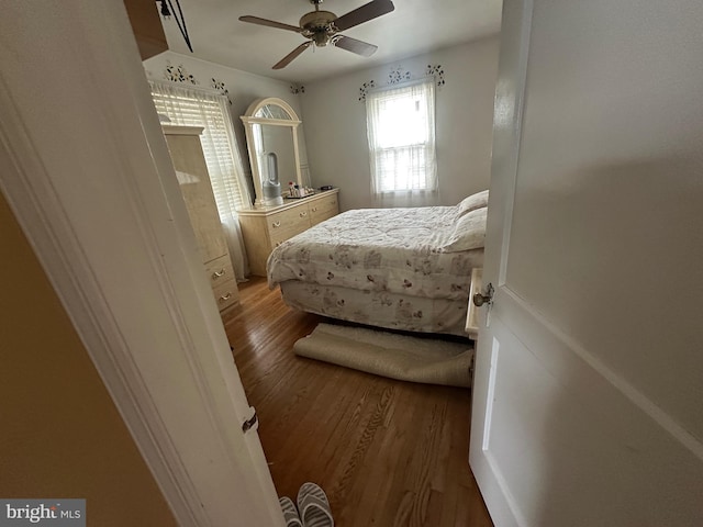 bedroom with ceiling fan and wood finished floors