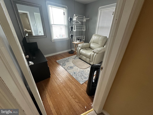 living room featuring hardwood / wood-style flooring and baseboards