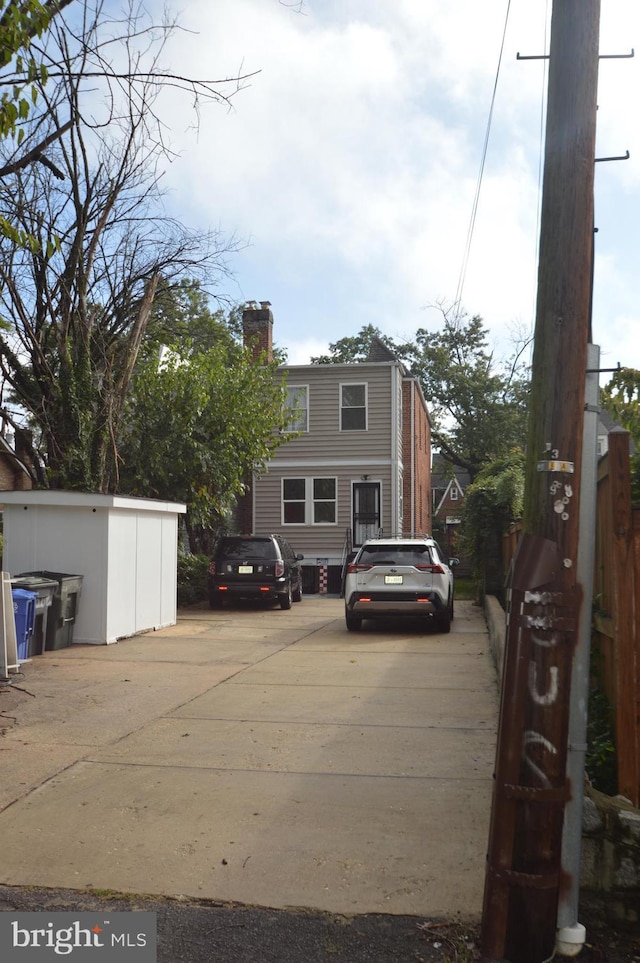 view of front of house with fence and a chimney