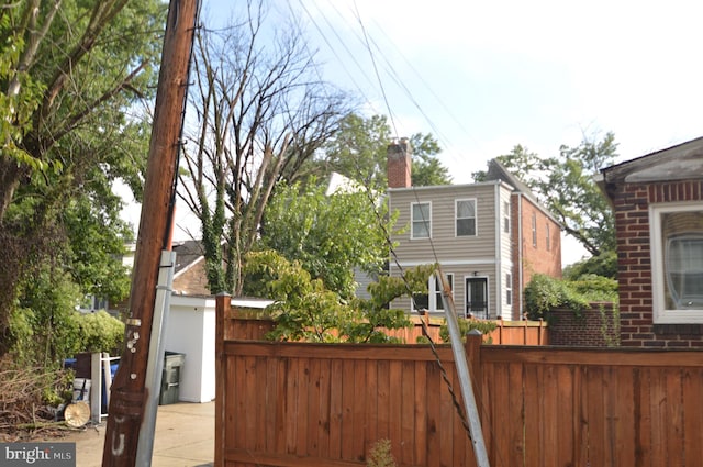 view of front of home featuring fence and a chimney