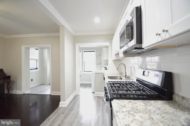 kitchen featuring a sink, white cabinets, a wealth of natural light, and stainless steel appliances